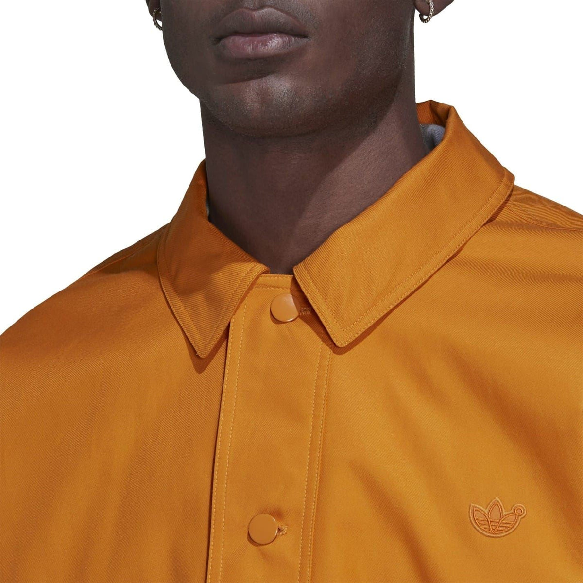 adidas Originals Tie Break jacket, stylish coat with sporty design, shown in a sleek black color with a zip-up front and stand-up collar.
