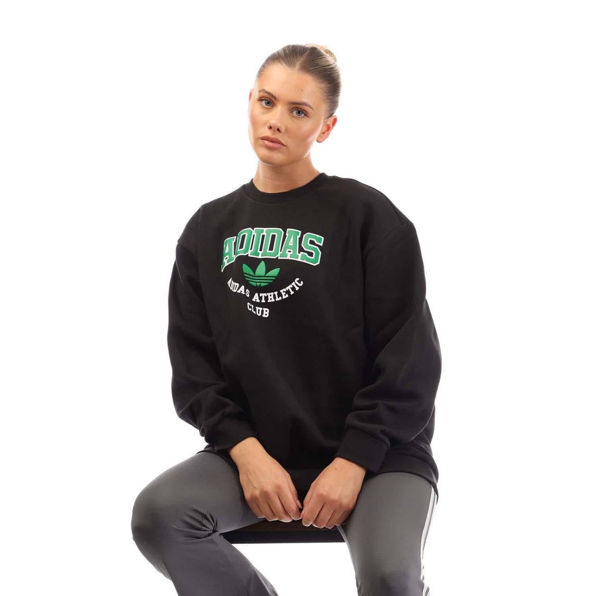 Black crewneck sweatshirt front view with green adidas athletic club logo
