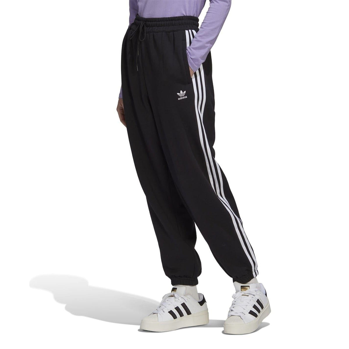 adidas Originals relaxed joggers in black, showing the comfortable fit and elastic waistband, suitable for casual wear.