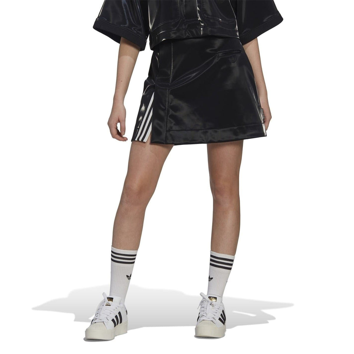 Black glossy mini skirt with side stripe accents and adidas logo patch