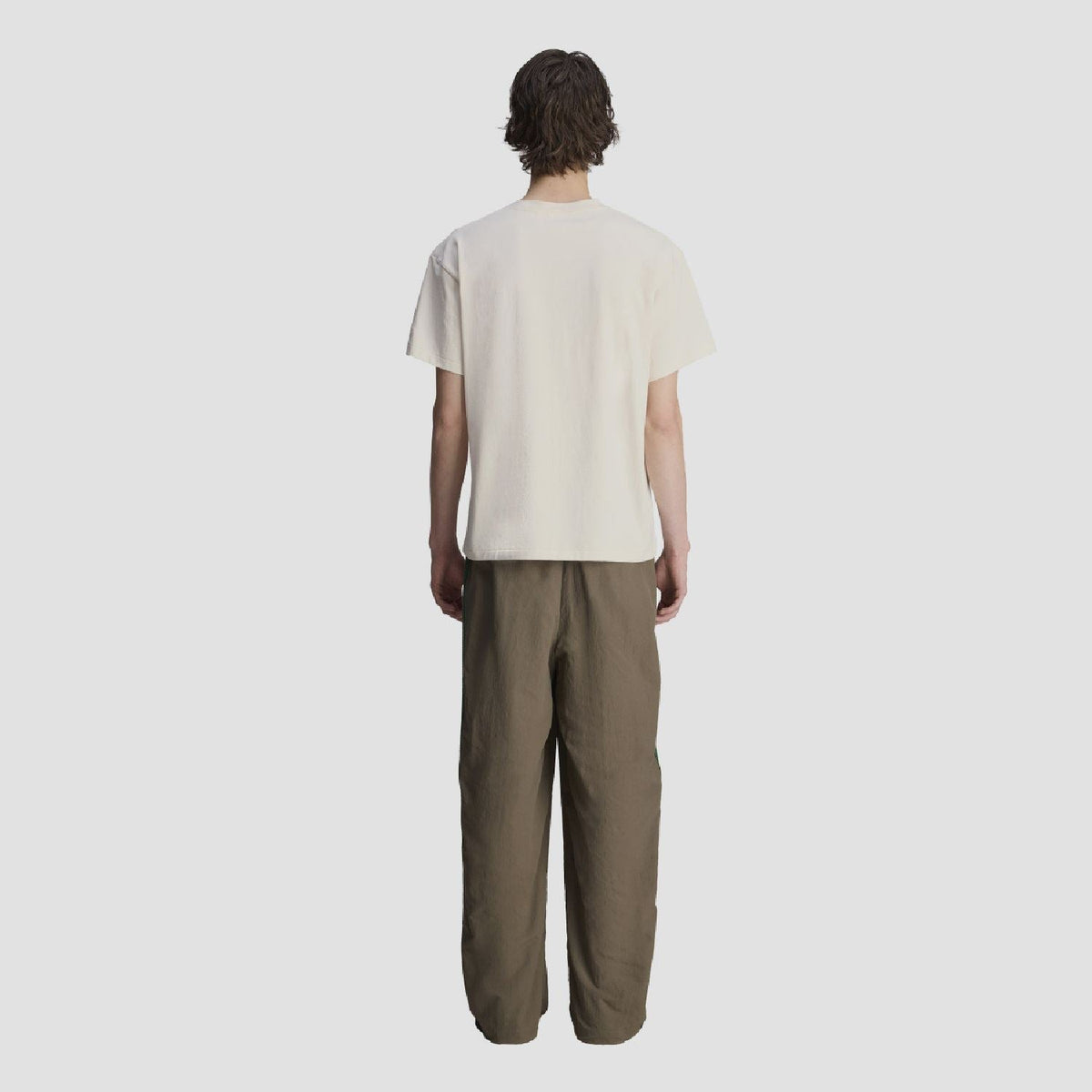 Chocolate track pants with elastic waist and cuffs, relaxed wide leg, green side stripes