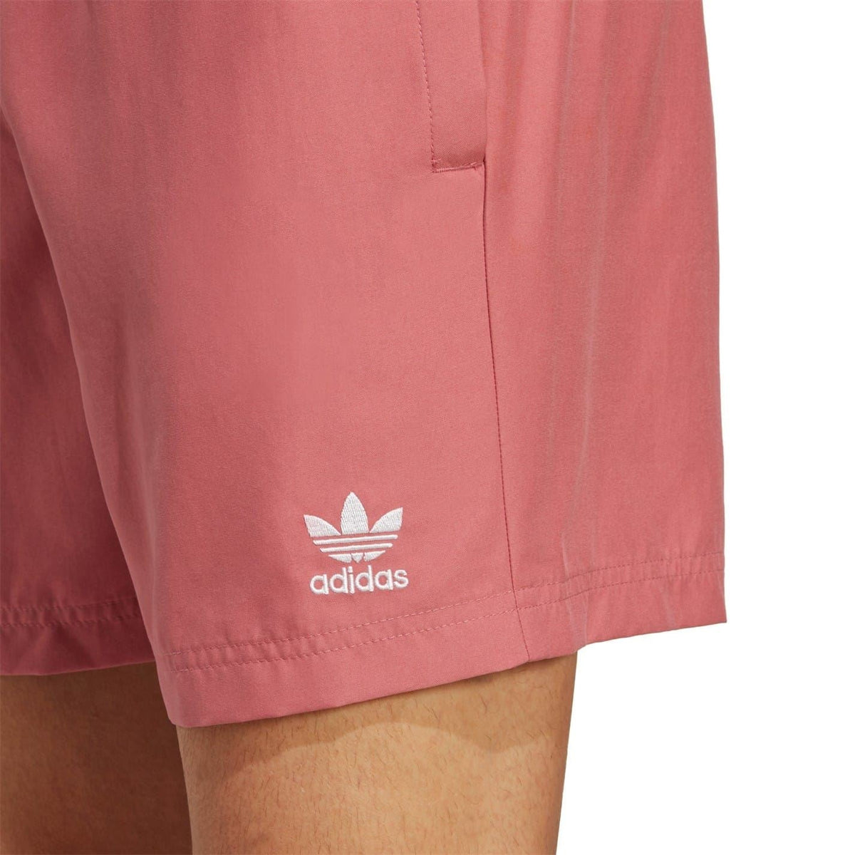 Pink swim shorts detail showing adidas logo and side seam