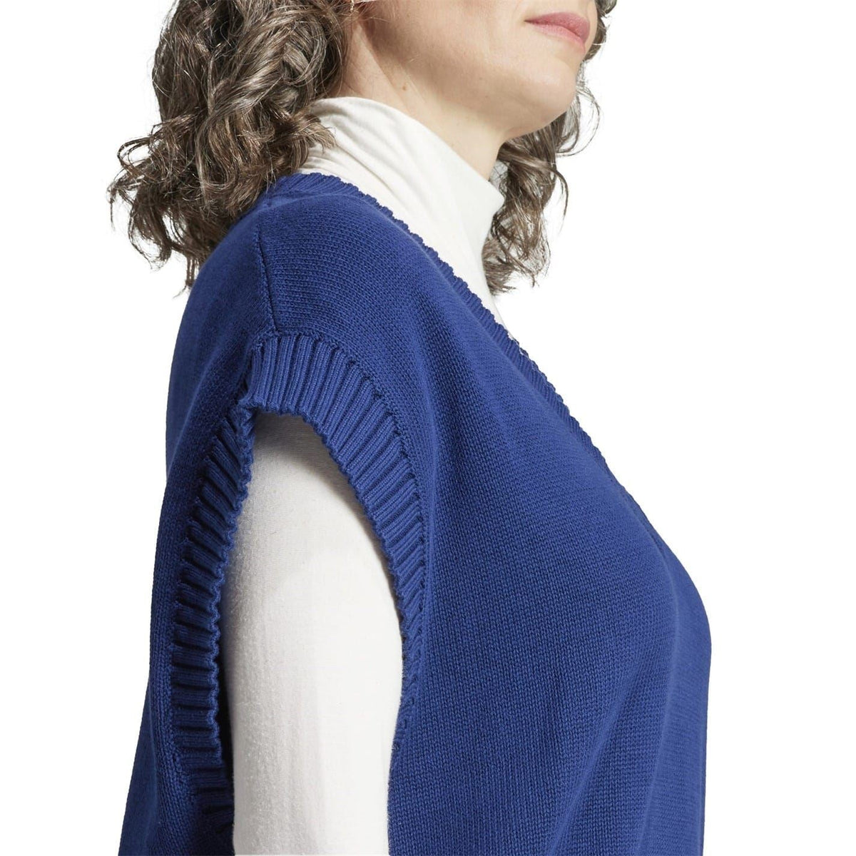 Blue ribbed knit gilet side view with textured knit and ribbed armhole