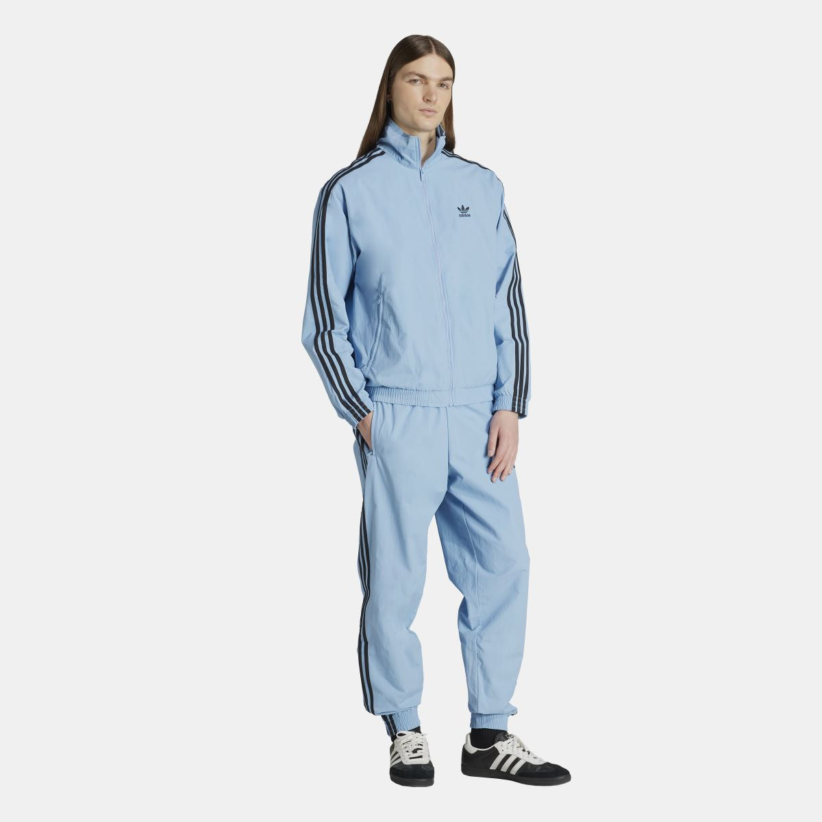 Light blue track jacket with stand collar, full zip, and black striped sleeves; matching pants