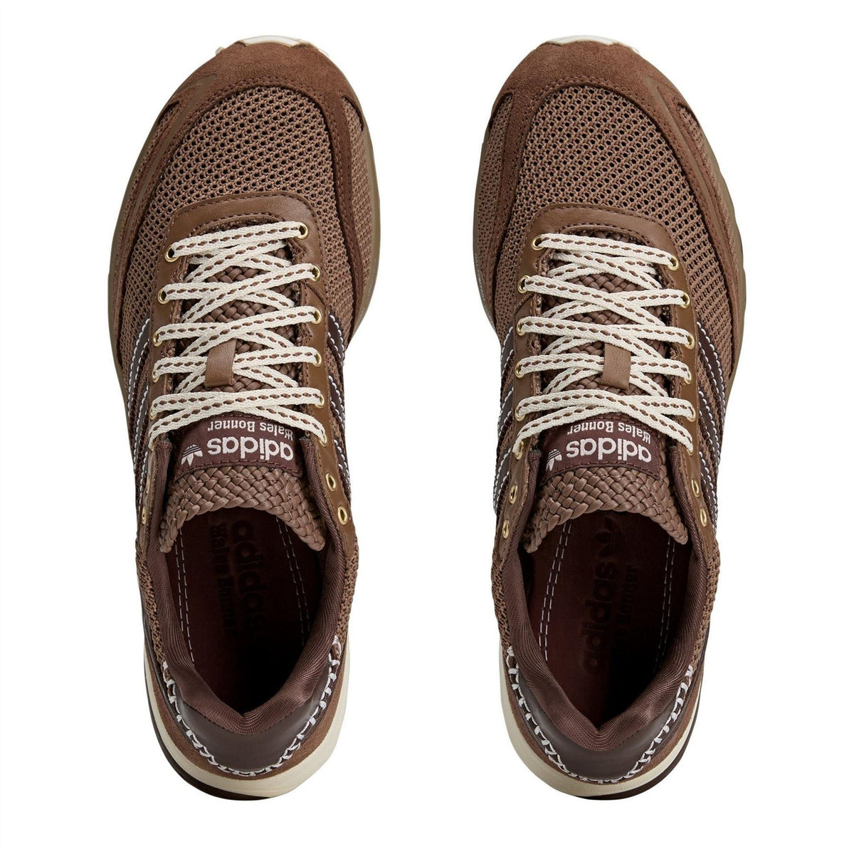Brown mesh lace-up sneakers with white laces and textured collar, toe view.