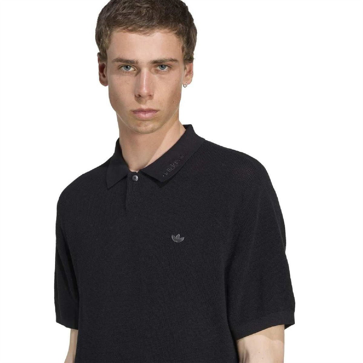 adidas Originals black polo shirt close-up of collar and button placket, chest logo