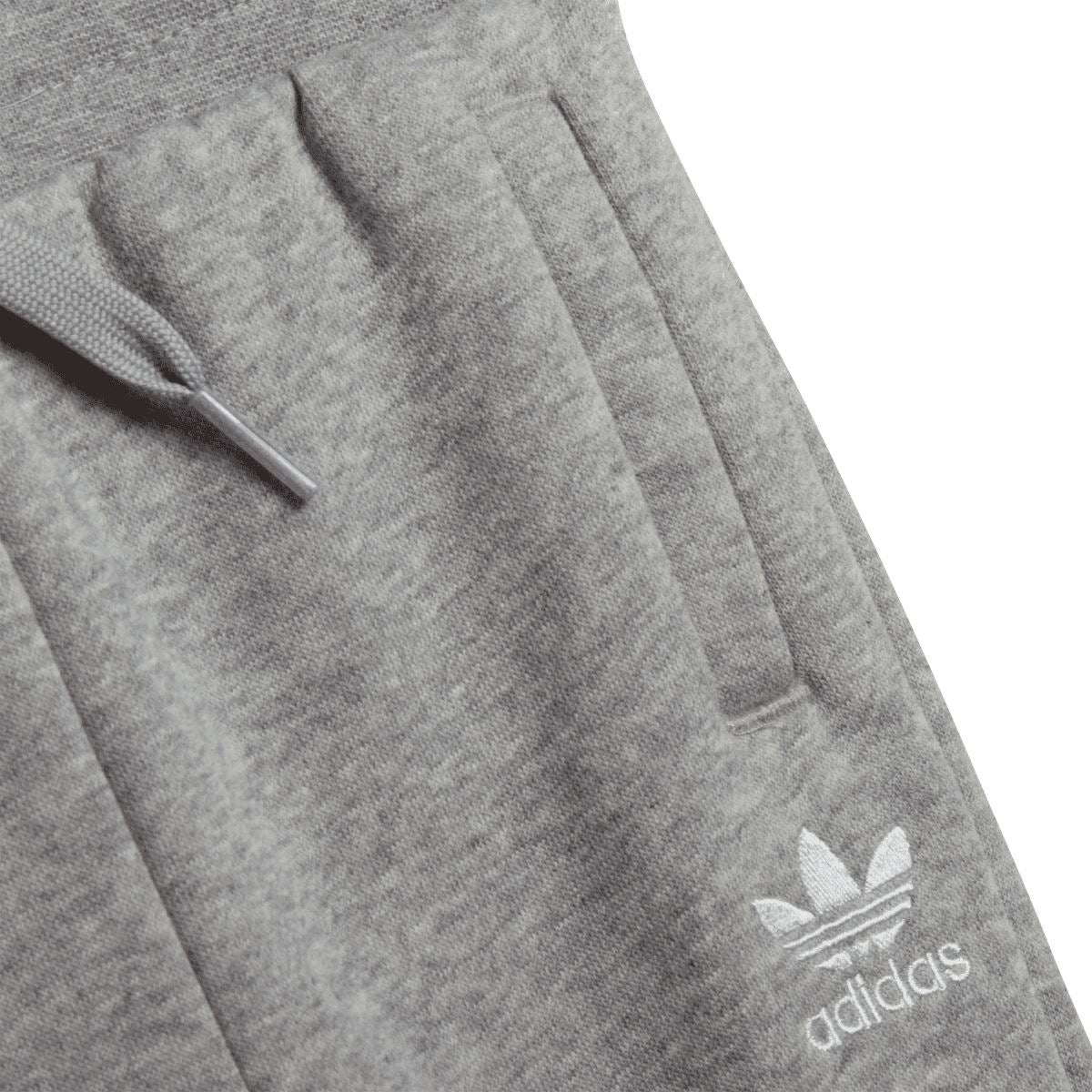 Grey infant jogger pants close-up with adidas logo on thigh pocket.