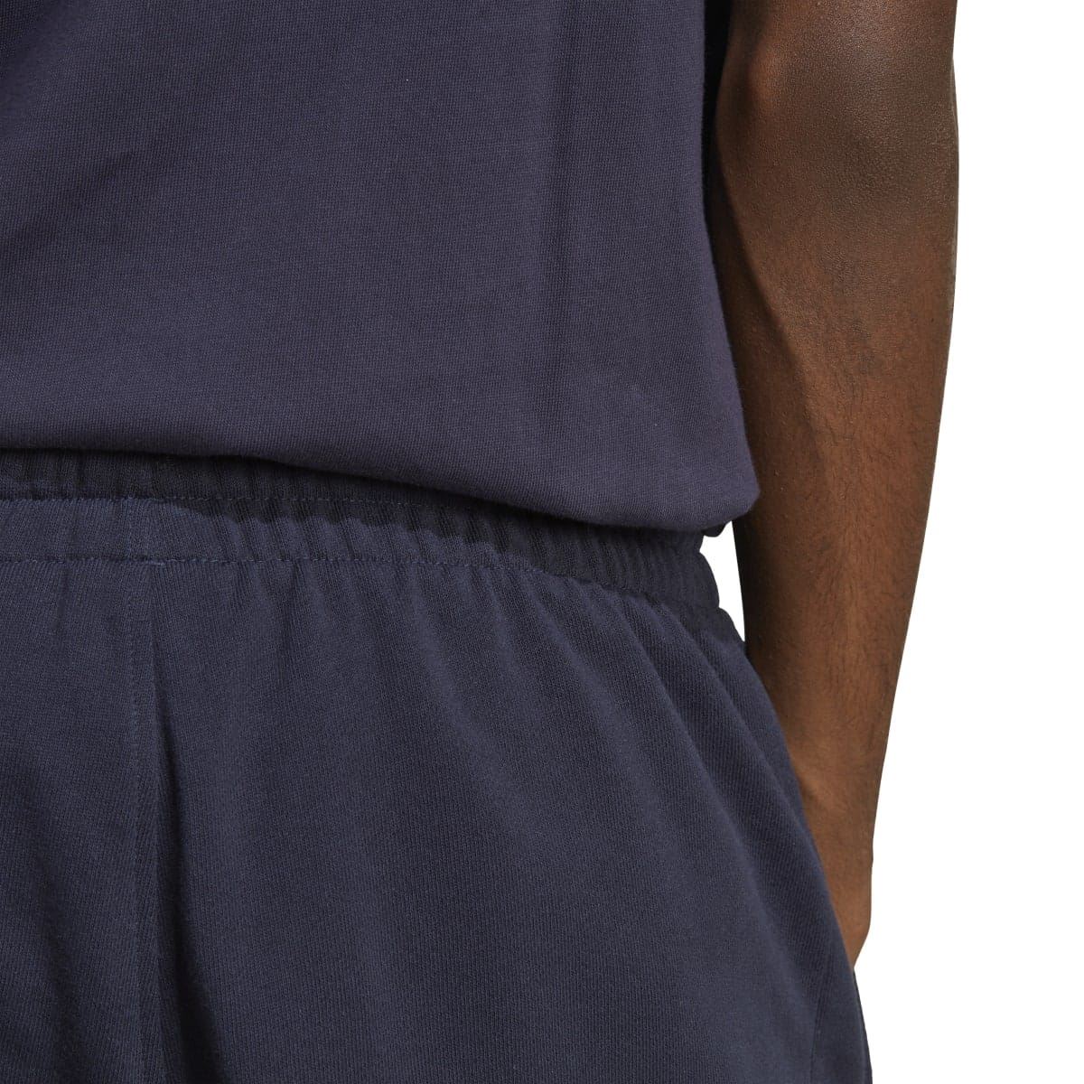 Navy joggers close-up: elastic waistband with smooth fabric finish