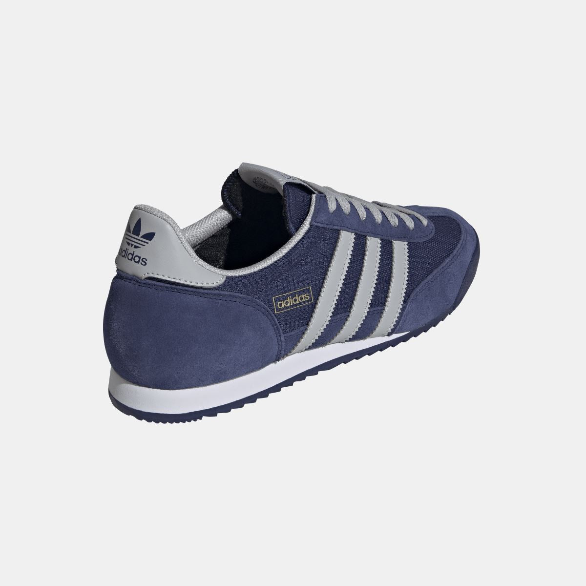 adidas Originals R71 shoes in classic white and black, featuring a sleek sneaker design with lace-up closure and stylish branding