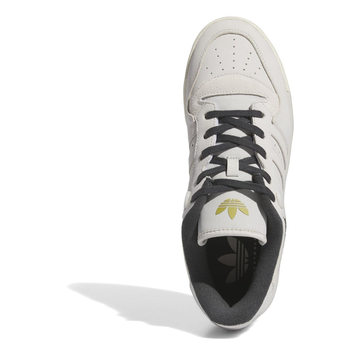 White low-top sneakers with black laces, lace eyelets, and front adidas logo