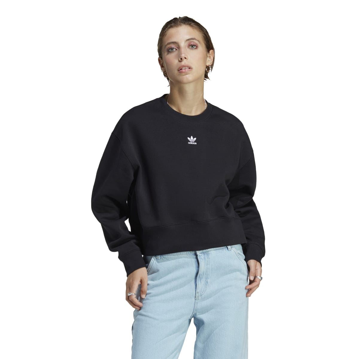 Black crewneck sweatshirt worn with light blue jeans; adidas Trefoil logo