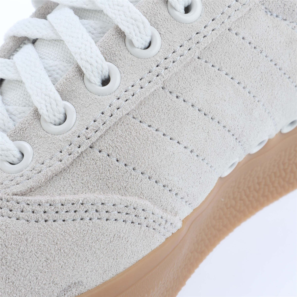 Close-up of white adidas 3MC trainers showing textured uppers and white laces