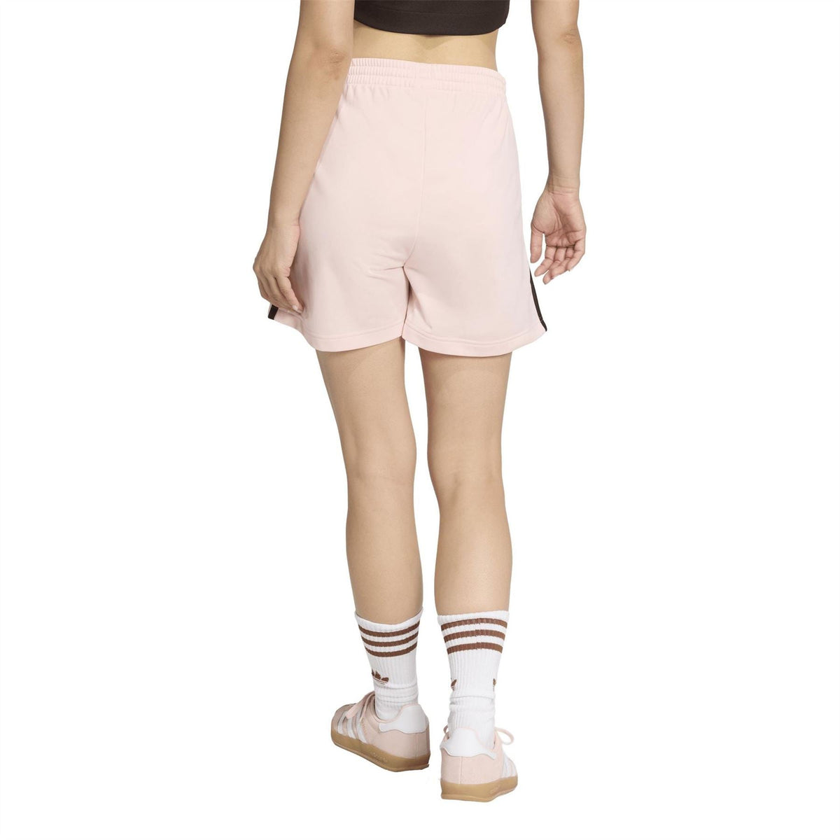 Light pink adidas shorts with elastic waist and black side stripe detail; above-knee length