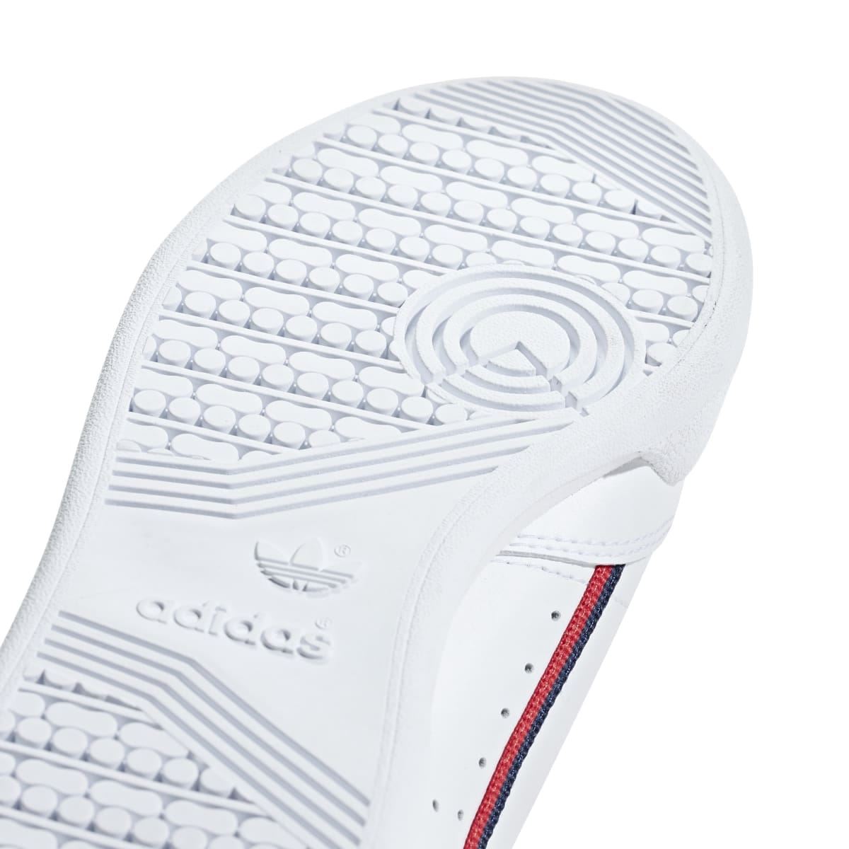 White Adidas Continental 80 junior shoe outsole close-up with circular traction pattern.