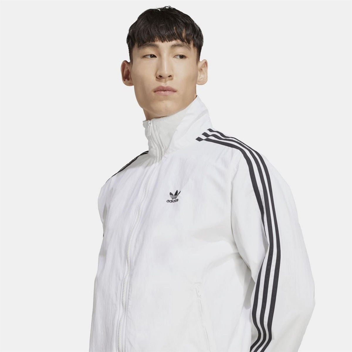 adidas Originals woven Firebird track top in black with colorful logo and striped cuffs, casual athletic wear for men and women