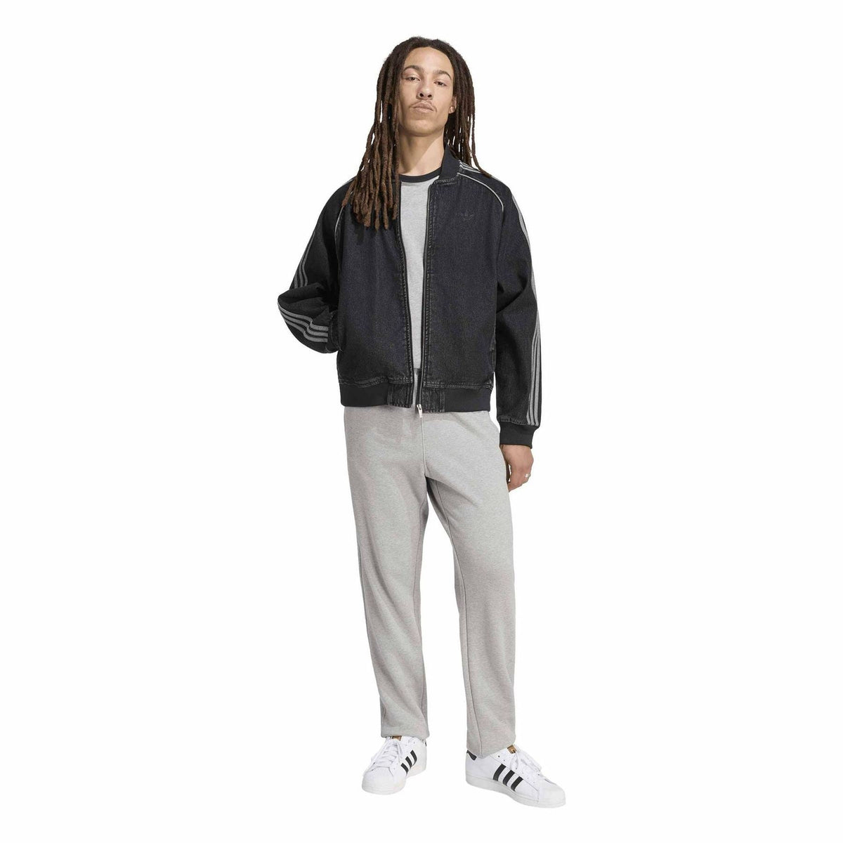 Black denim bomber jacket with full zip, ribbed hem, and three-stripe athletic sleeves.
