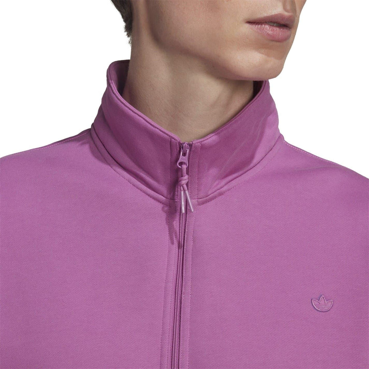 Purple half-zip crew sweatshirt neck close-up with stand collar and small logo.