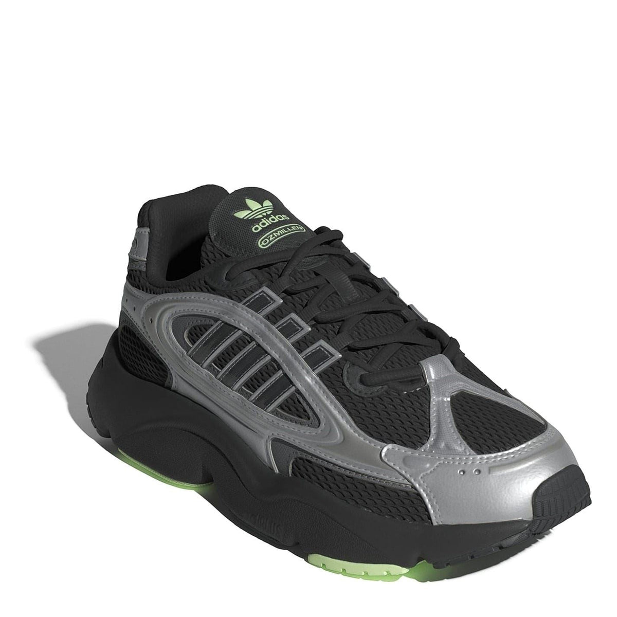 Low-top lace-up sneakers with black mesh, silver overlay, and green heel detail