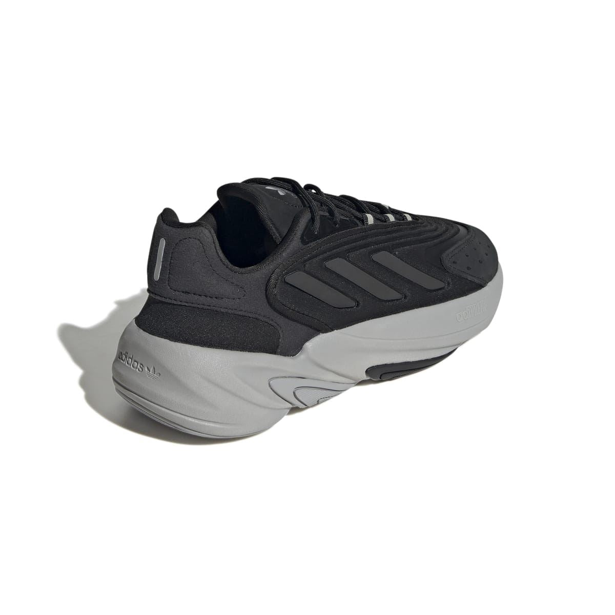 Black lace-up trainers from the heel side with padded collar and chunky sole