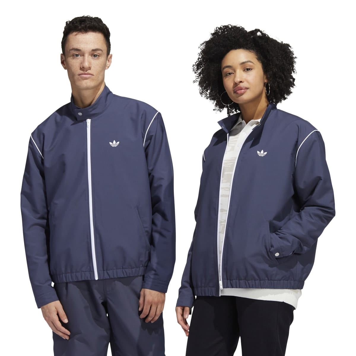 adidas navy track top worn by models, full zip front, stand collar, white stripe trim