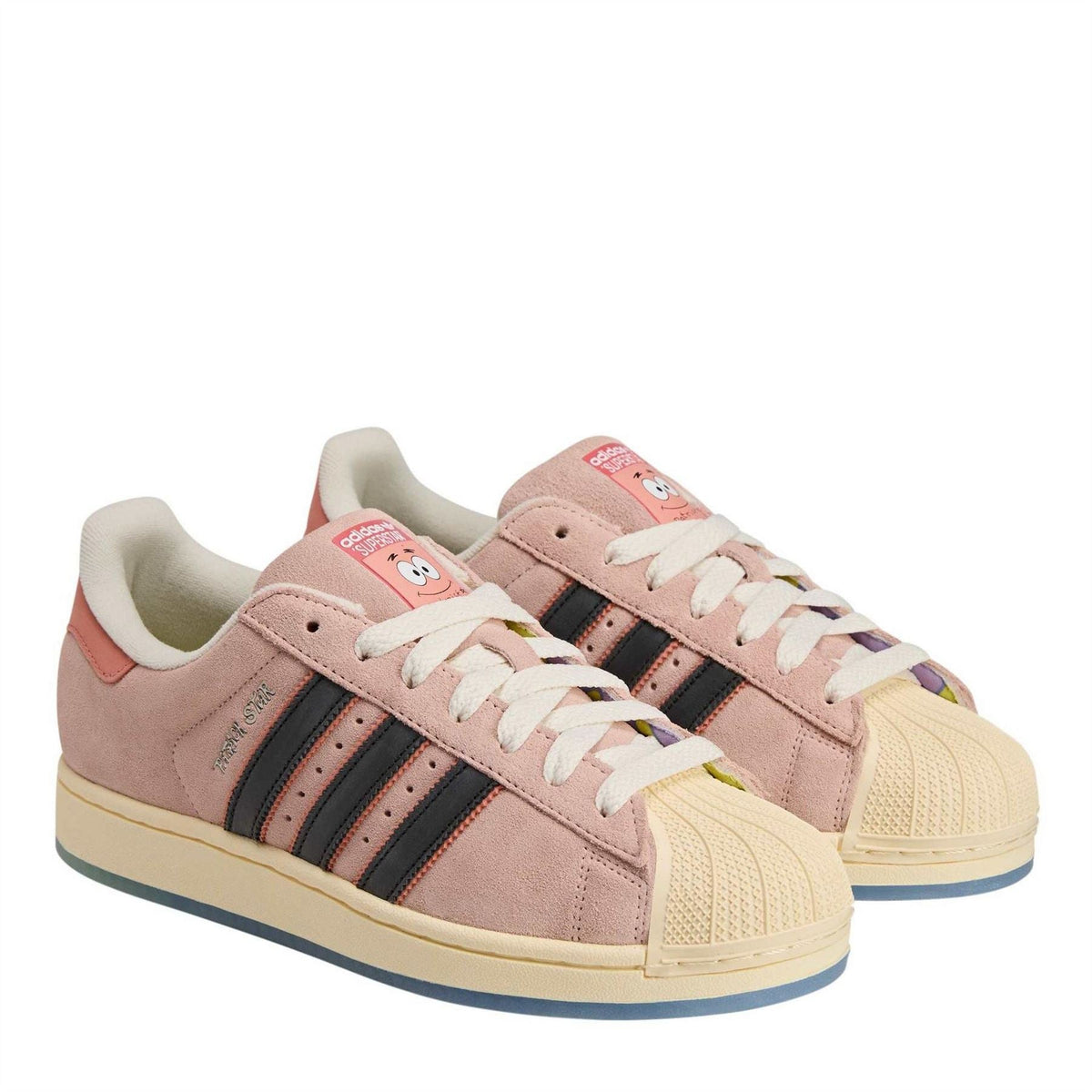 Pair of pink low-top sneakers with black stripes and white laces, side view