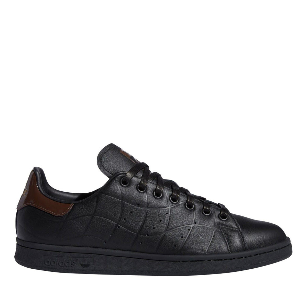 Black leather low-top trainers with brown heel panel, lace-up design and textured sole