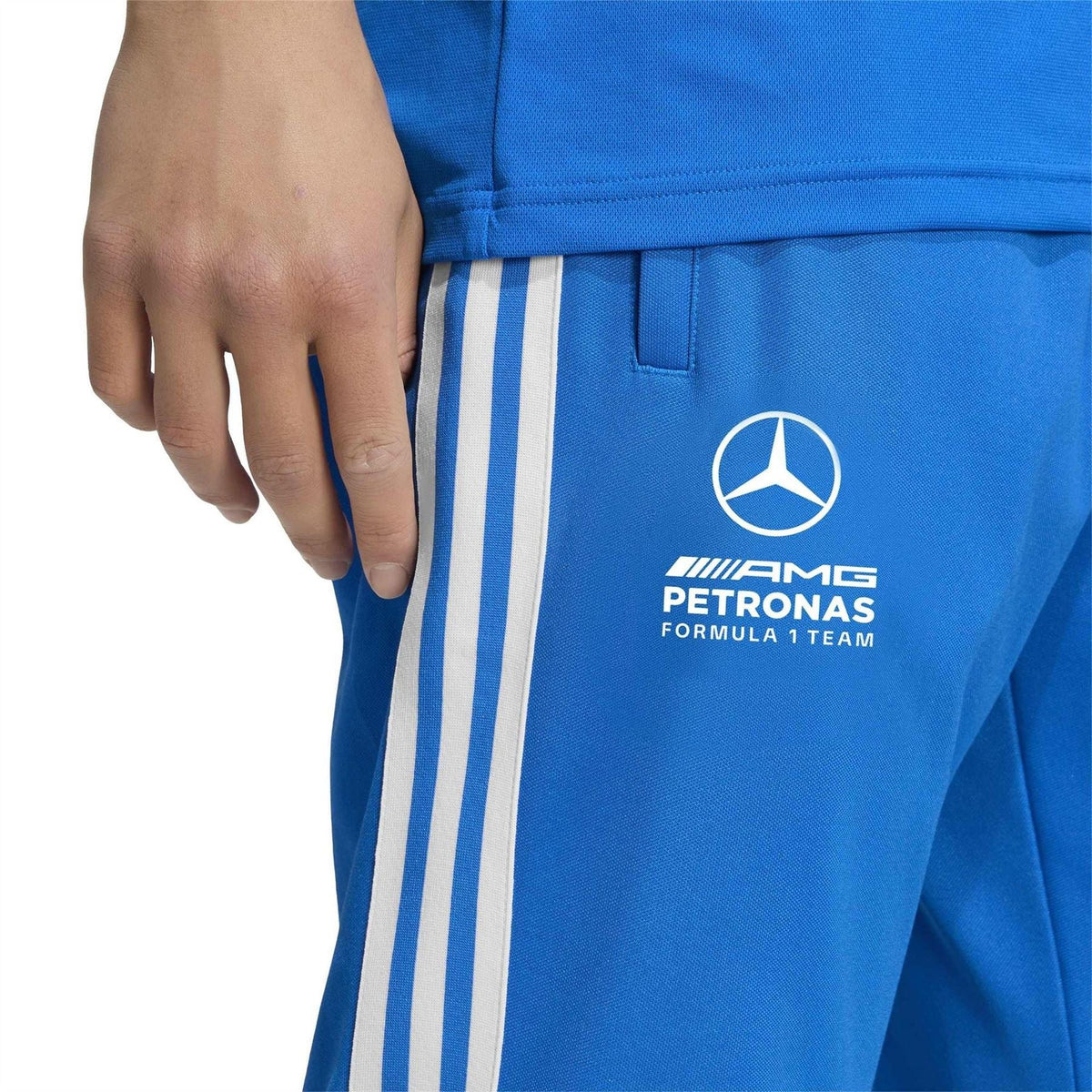 Blue track pants with logo patch and three white vertical stripes