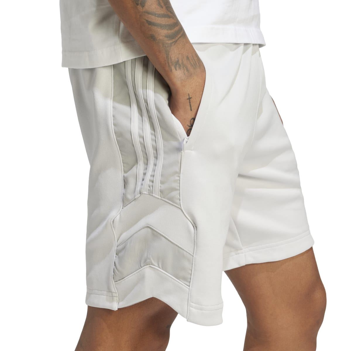 Light grey shorts close-up showing layered pocket opening and elastic waistband