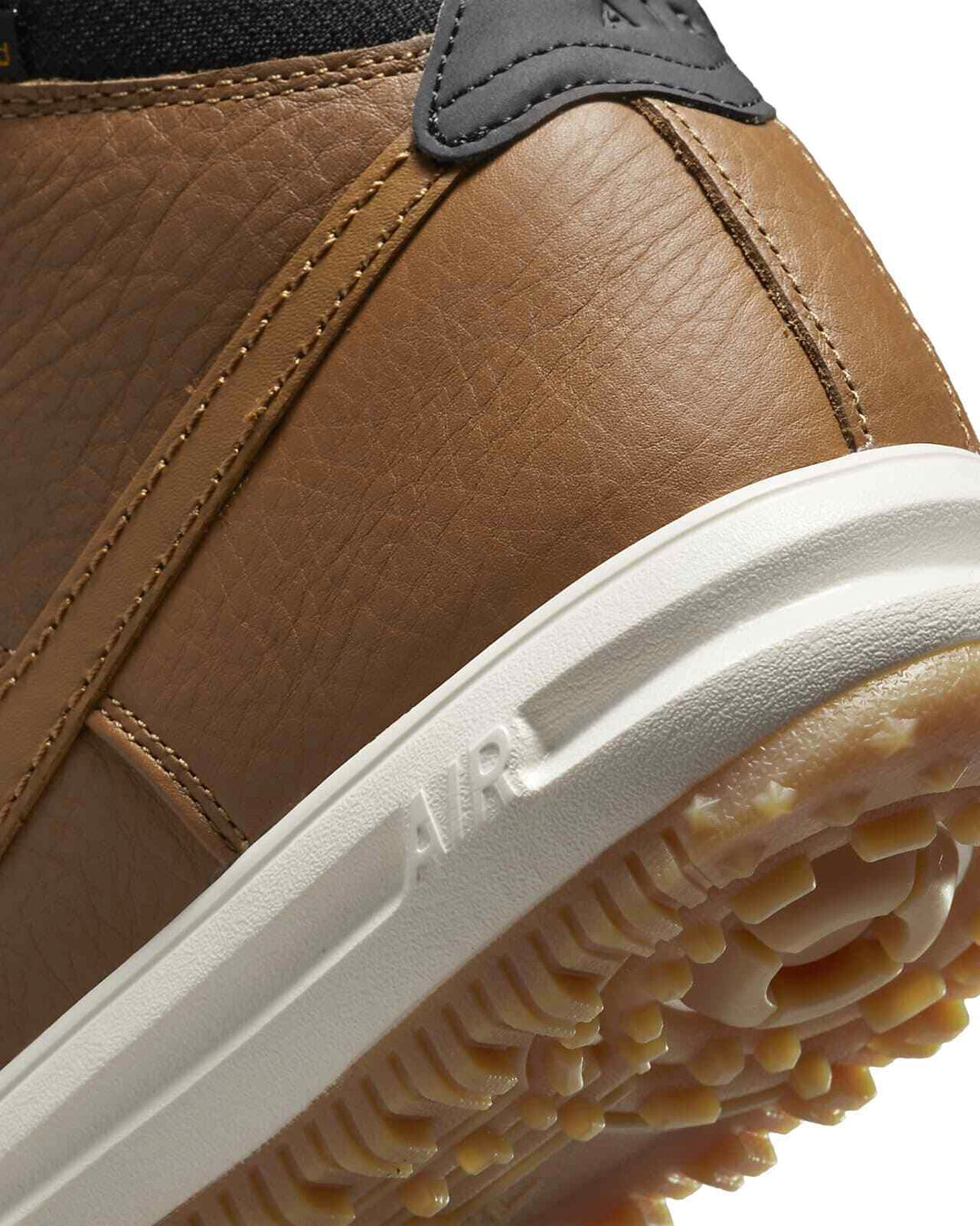 Men's Nike duckboot close-up of brown leather upper and white midsole edge