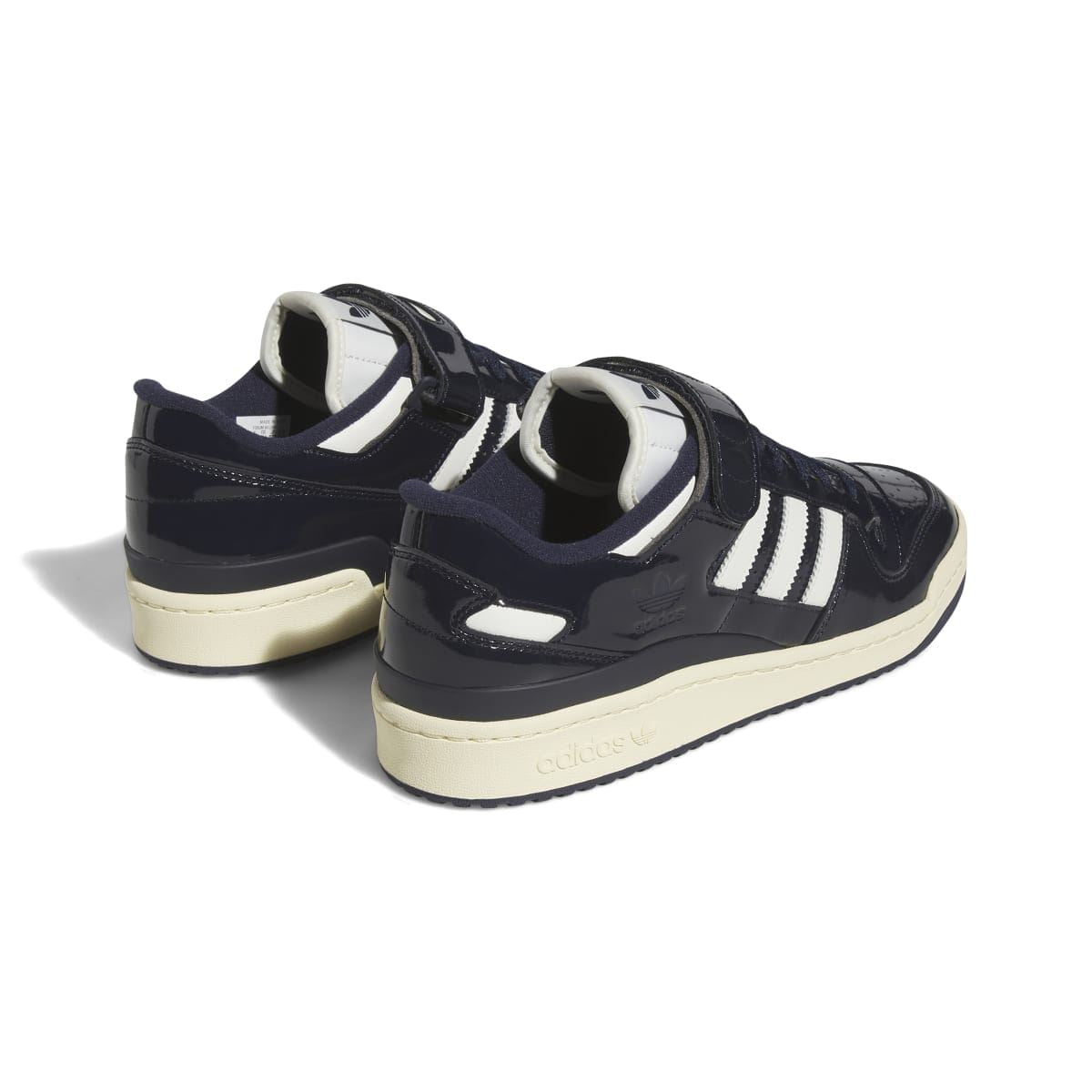 Back view of dark navy adidas low-top trainers with hook-and-loop strap and off-white sole