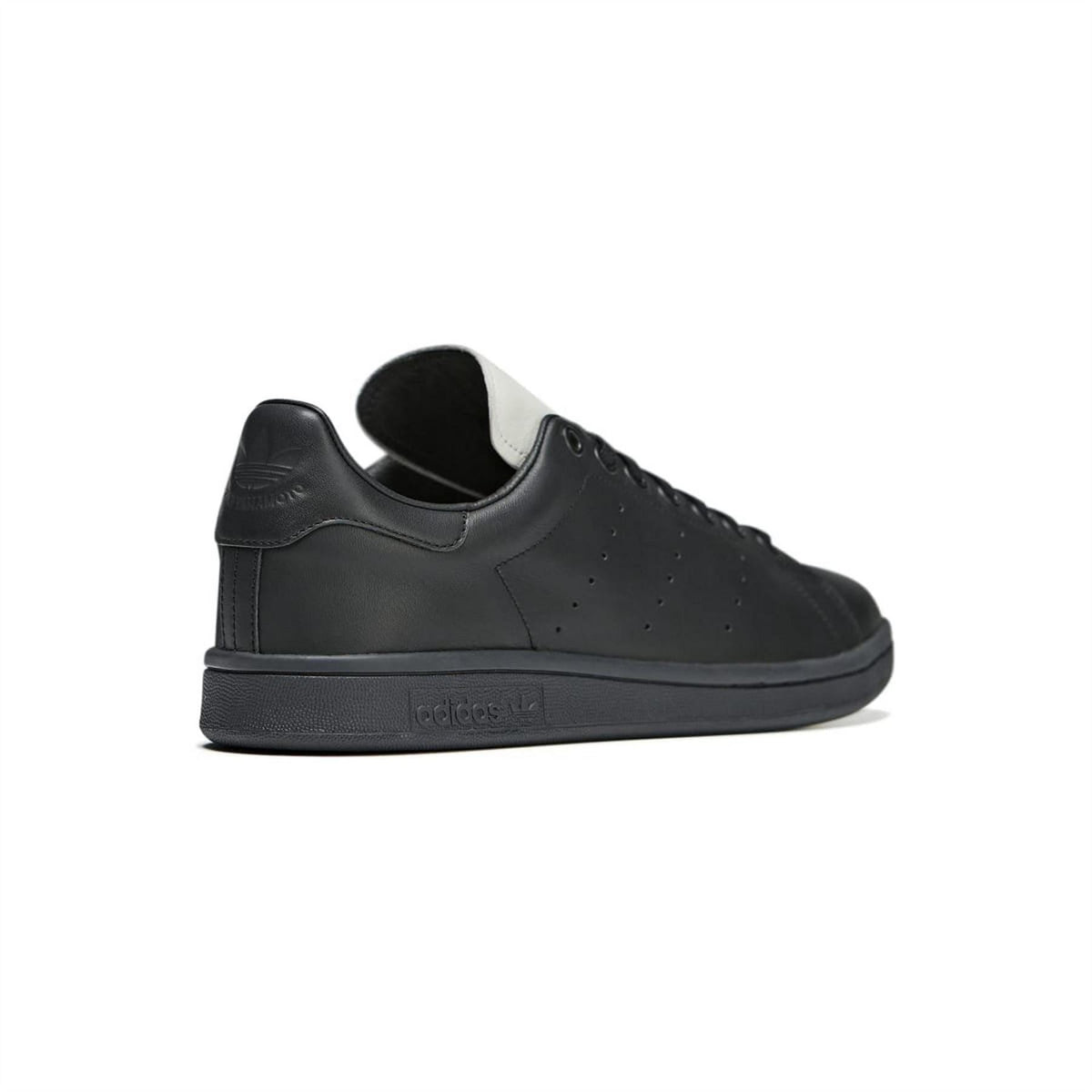 Black leather low-top sneaker with white sock collar and perforated side panels