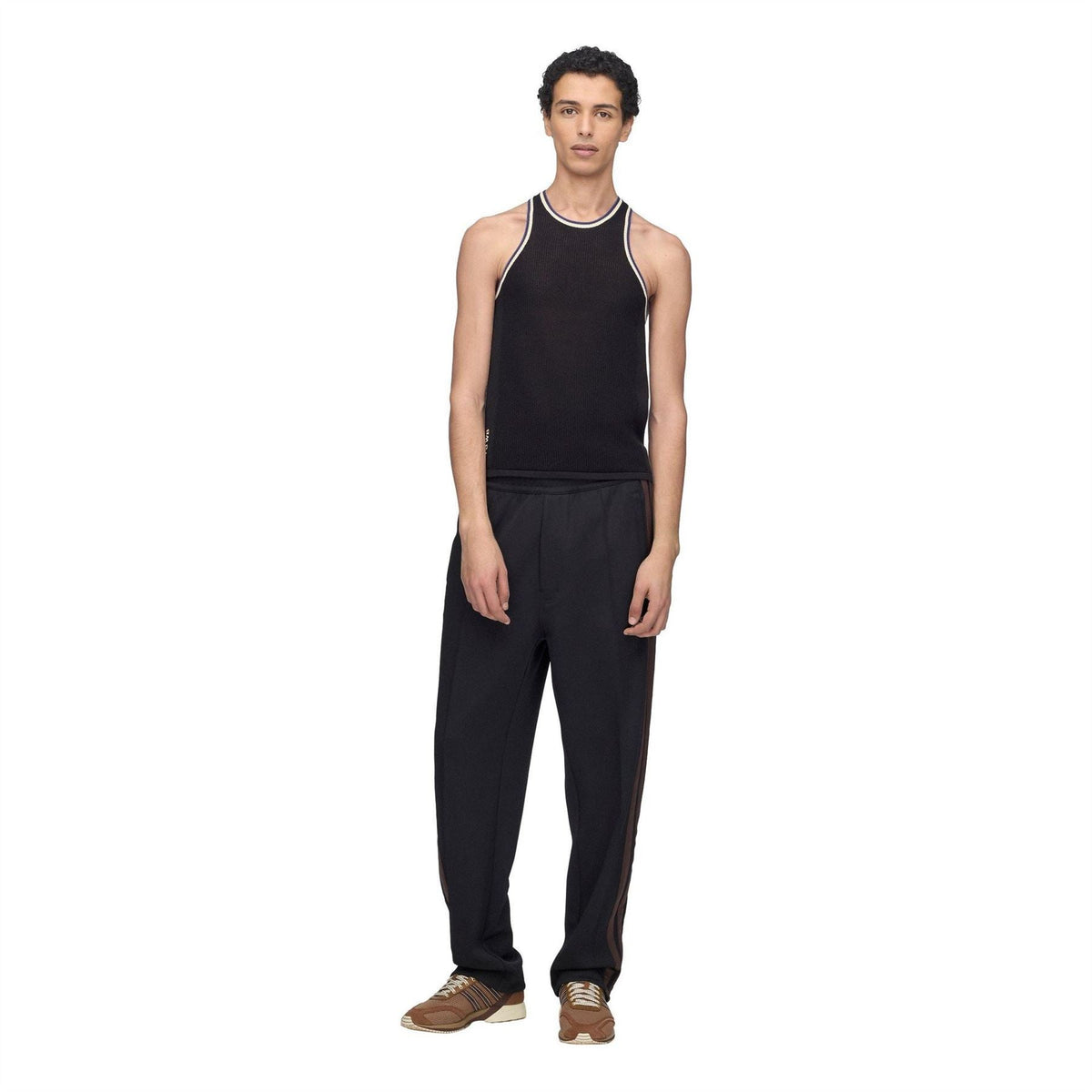 Black knit tank top with contrast trim, worn with black pants