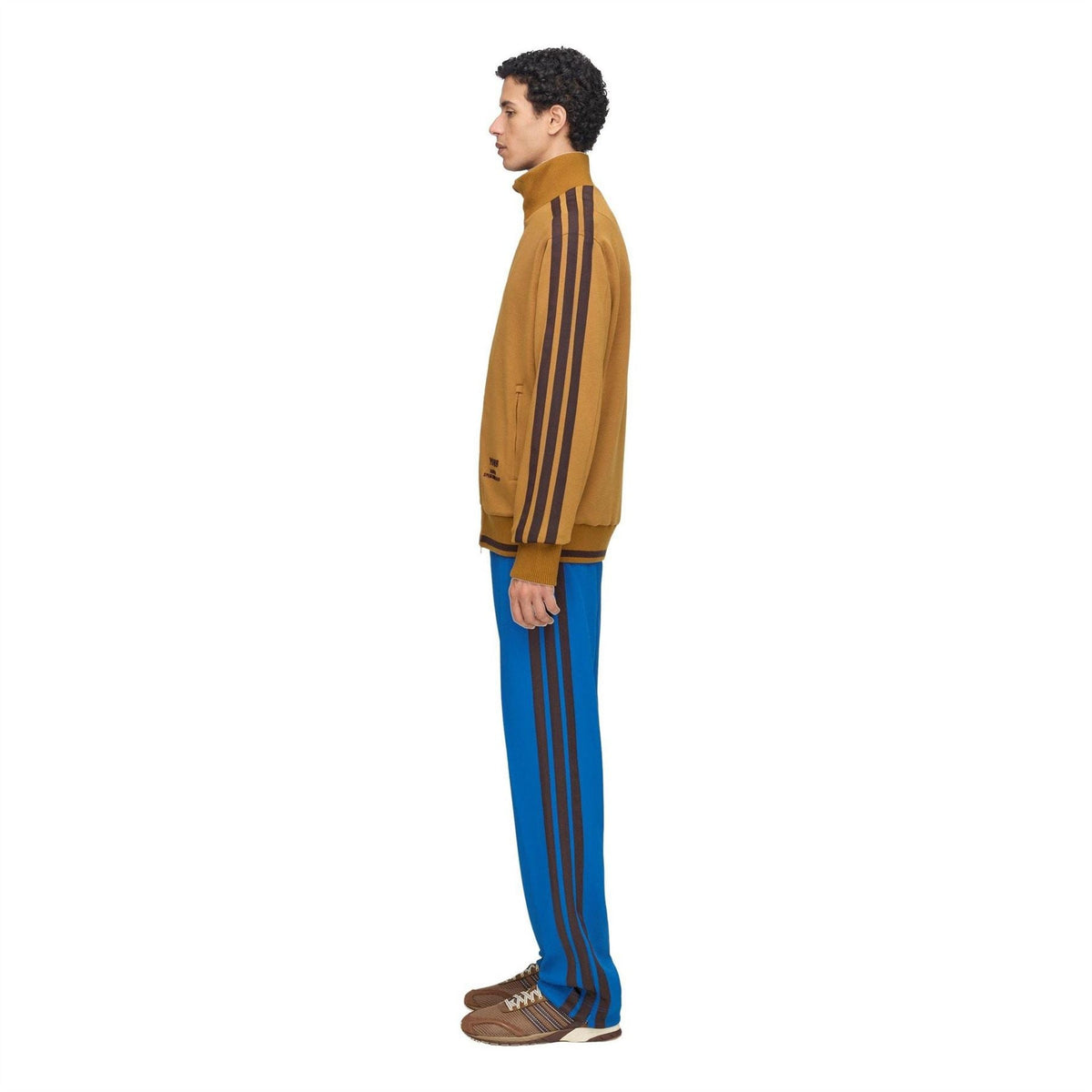 Men's tan track top with dark vertical sleeve stripes and ribbed cuffs; full-zip front.