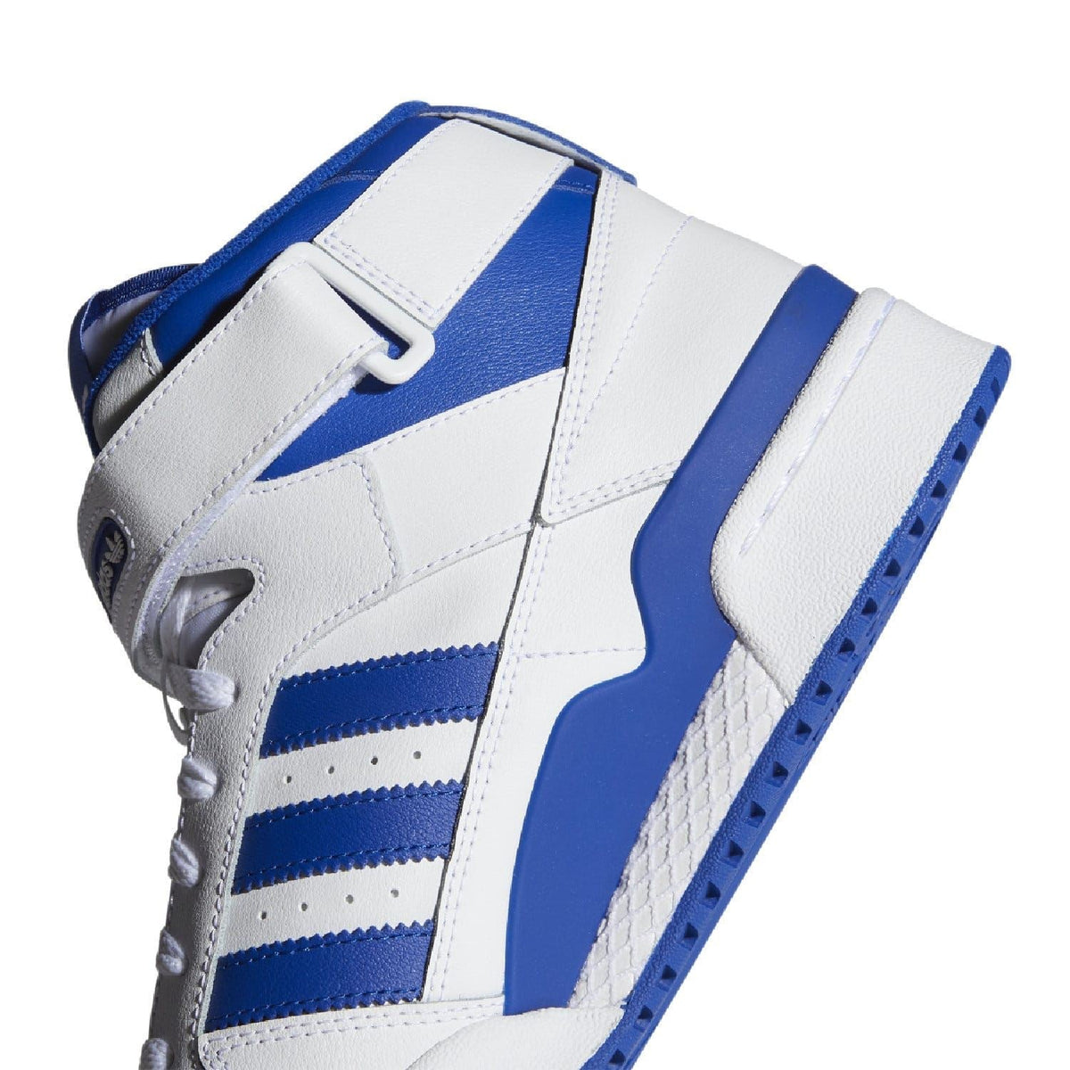 White and blue mid-top trainers close-up of ankle strap and side stripes