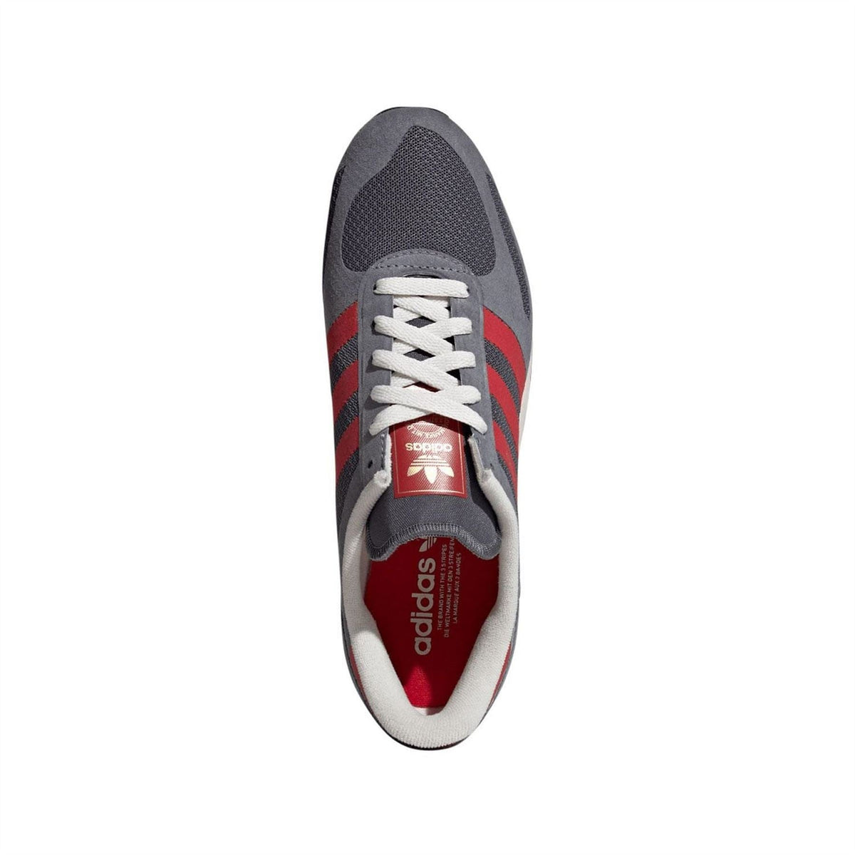 Grey and red adidas trainers, side view with white laces and red adidas logo tongue