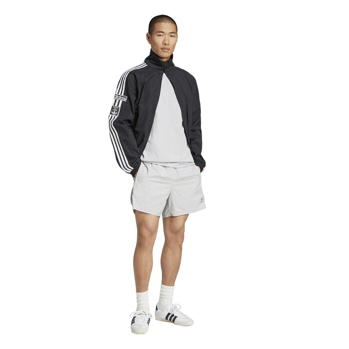 Light grey adidas Sprinter shorts with elastic waistband and knee-length cut