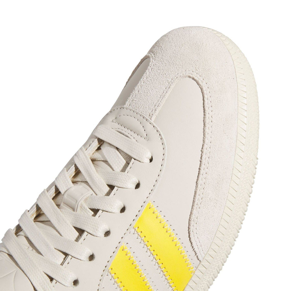 Close-up of adidas Samba trainers laces and white leather with yellow 3-Stripes