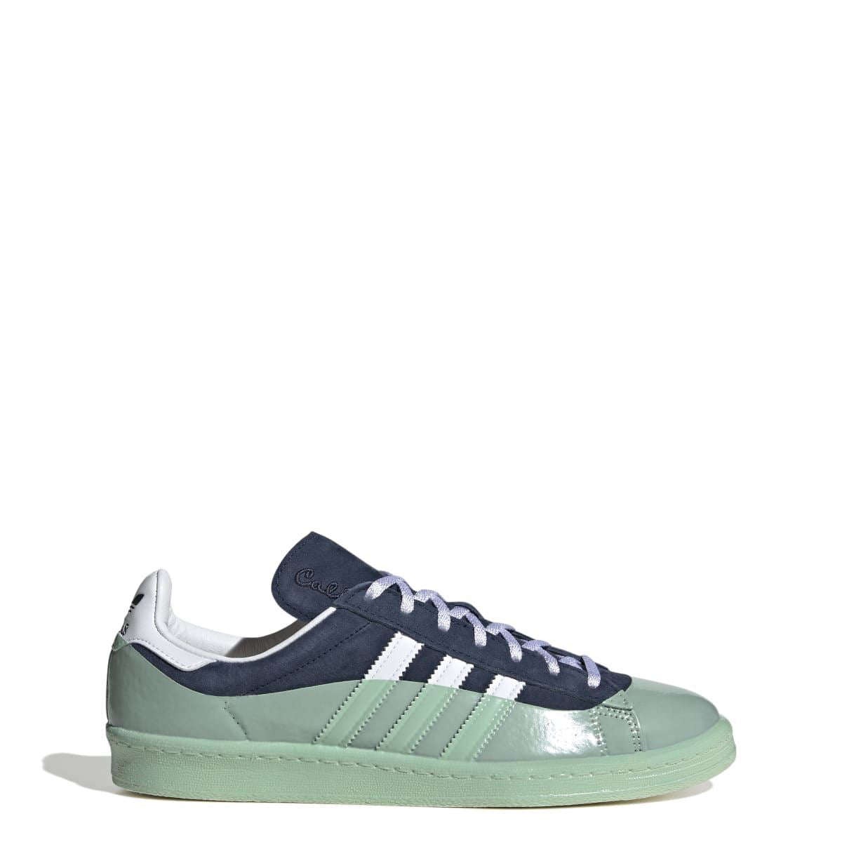 Sneakers with navy suede, mint leather panels, white stripes, and off-white laces
