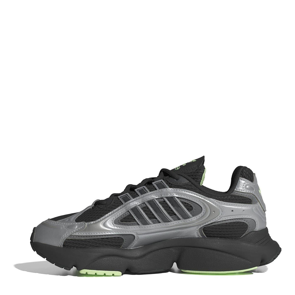 Low-top lace-up sneakers with black upper, silver side panels, and green outsole trim