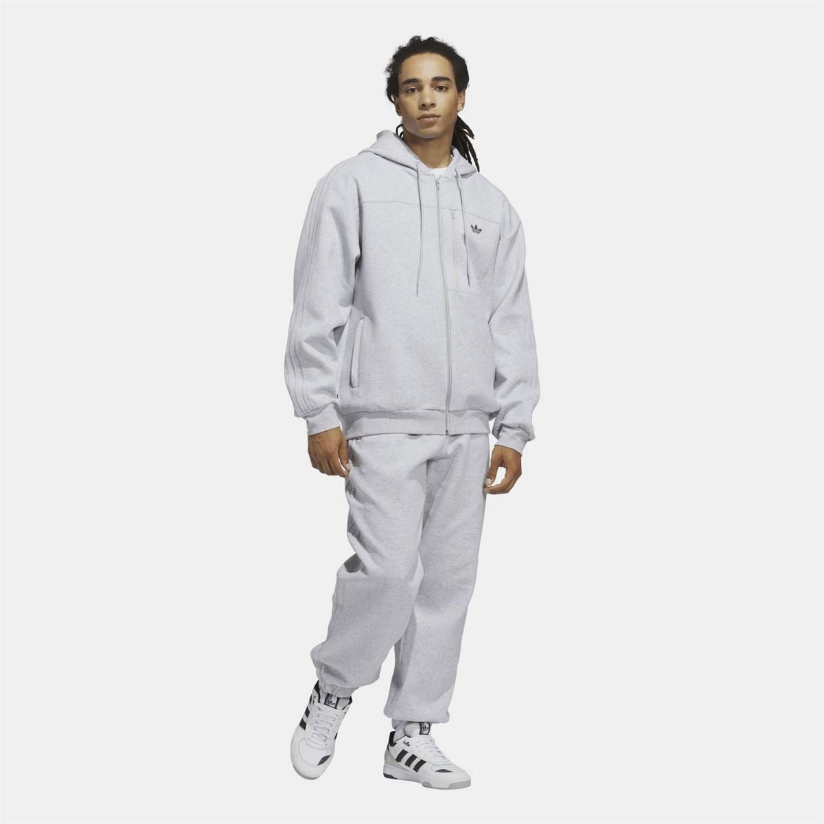 Grey fleece zip-up hoodie worn with drawstring hood and ribbed cuffs