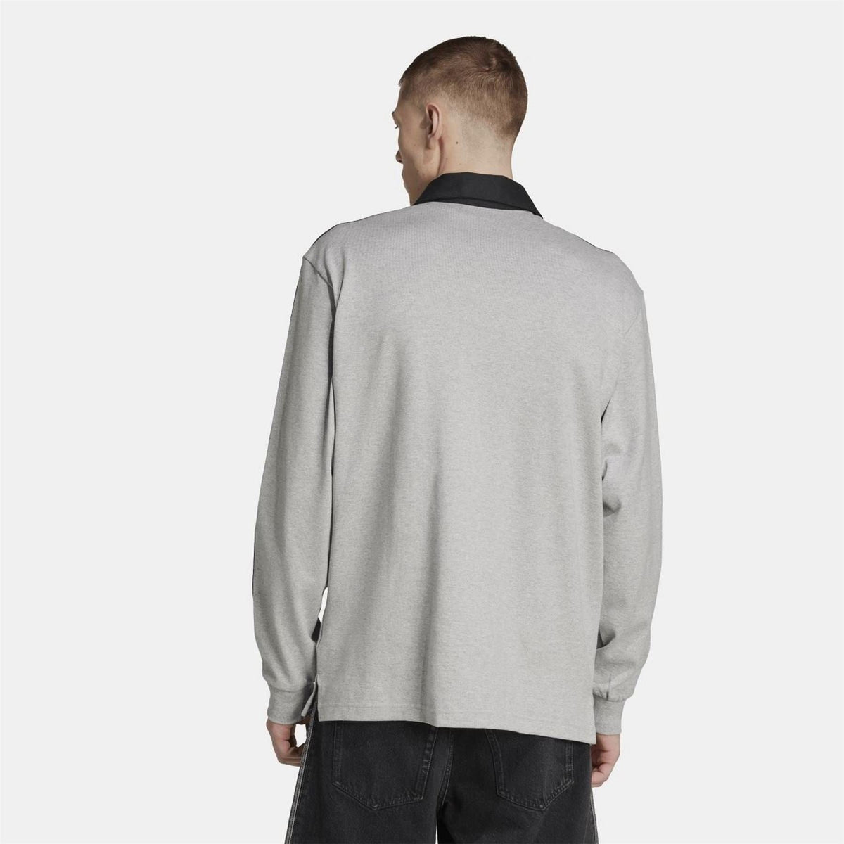 Grey rugby polo shirt with black collar and three-stripe sleeves, rear view on model.