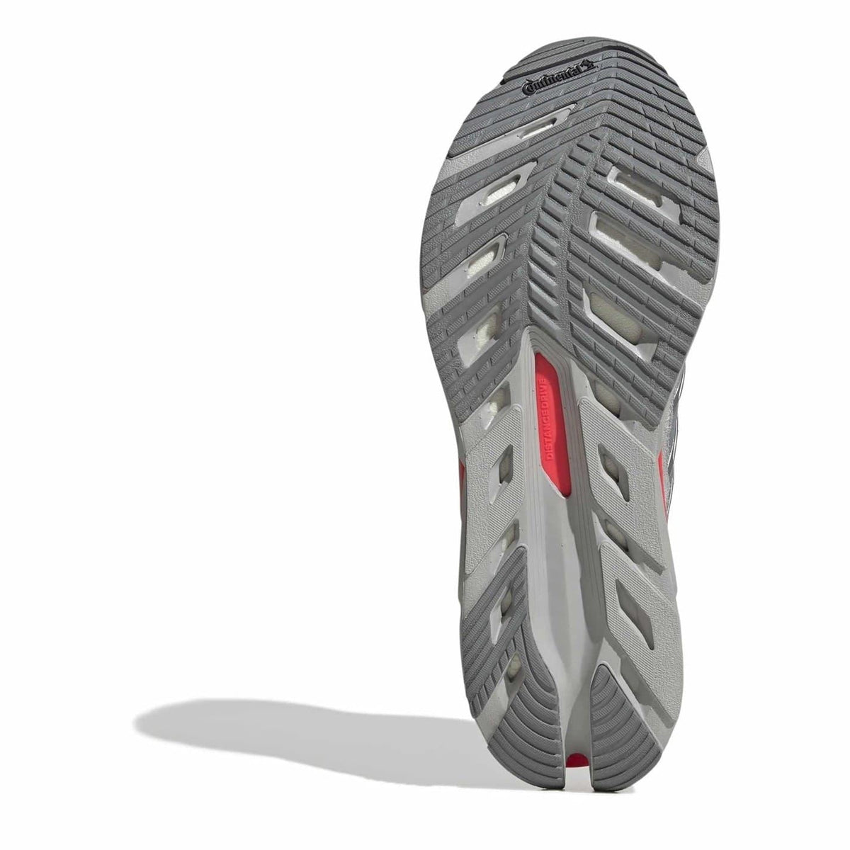Dark grey sneaker outsole with deep tread and red side stripe detail
