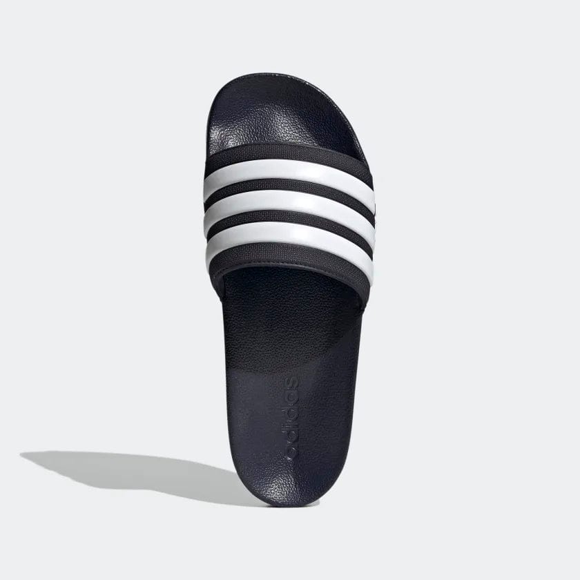 Black shower slide sandal with white triple stripes across the strap and cushioned footbed