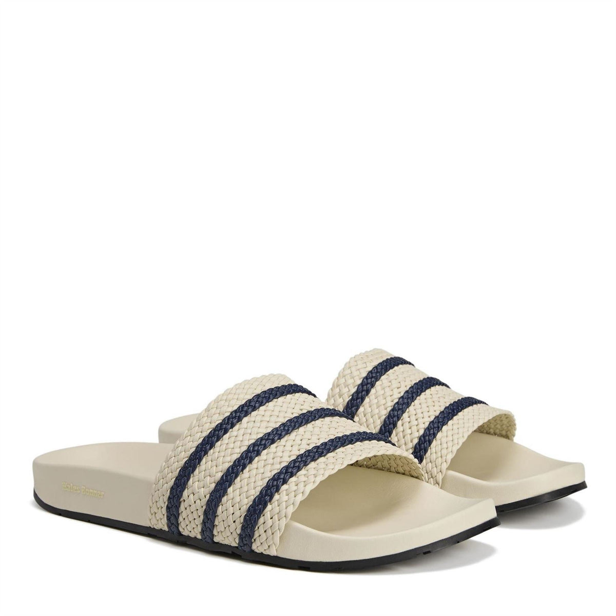 Pair of Wonder White adidas adilette slides with woven strap and navy triple stripes