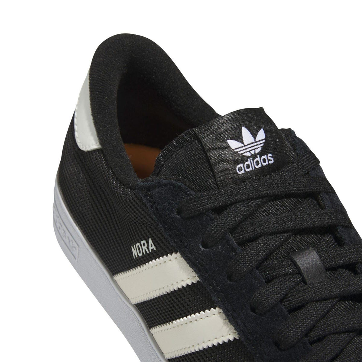 Black adidas trainers with white side stripes and adidas logo on the heel