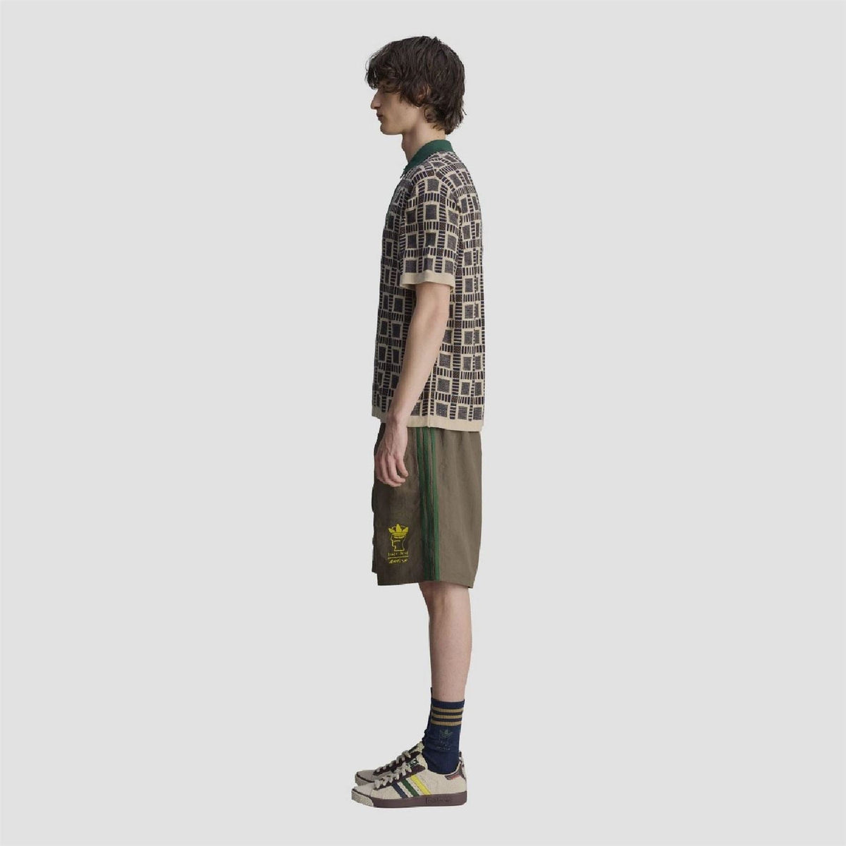 adidas Originals polo shirt side profile with geometric print and green button placket