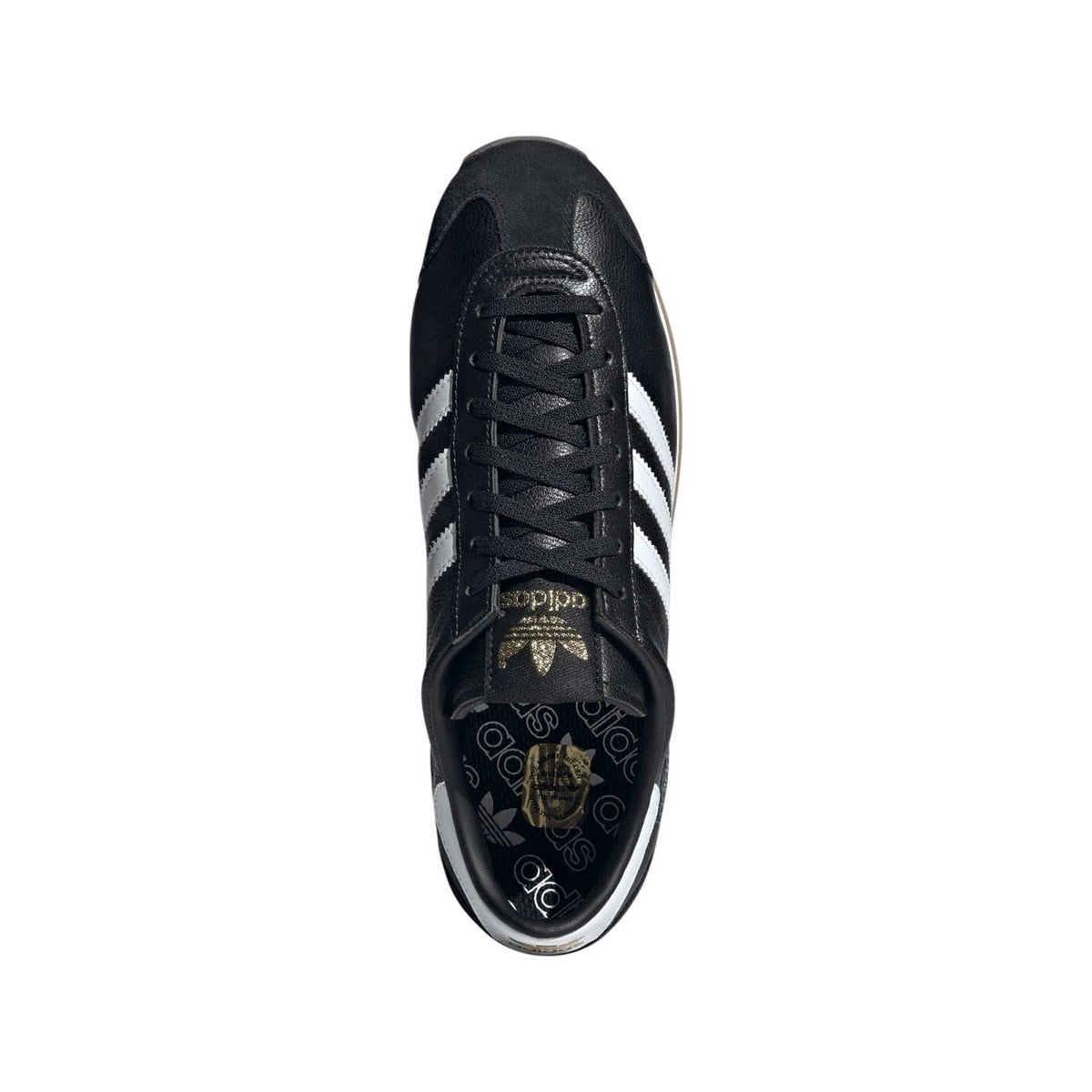 Black adidas trainers with black laces and white heel stripes; patterned tongue lining