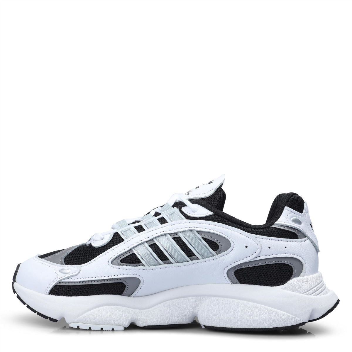 White lace-up sneakers with black panels, adidas three stripes, and thick midsole