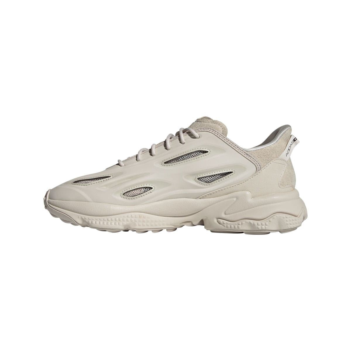 adidas Ozweego trainers in light cream, front three-quarter view with perforated side panels