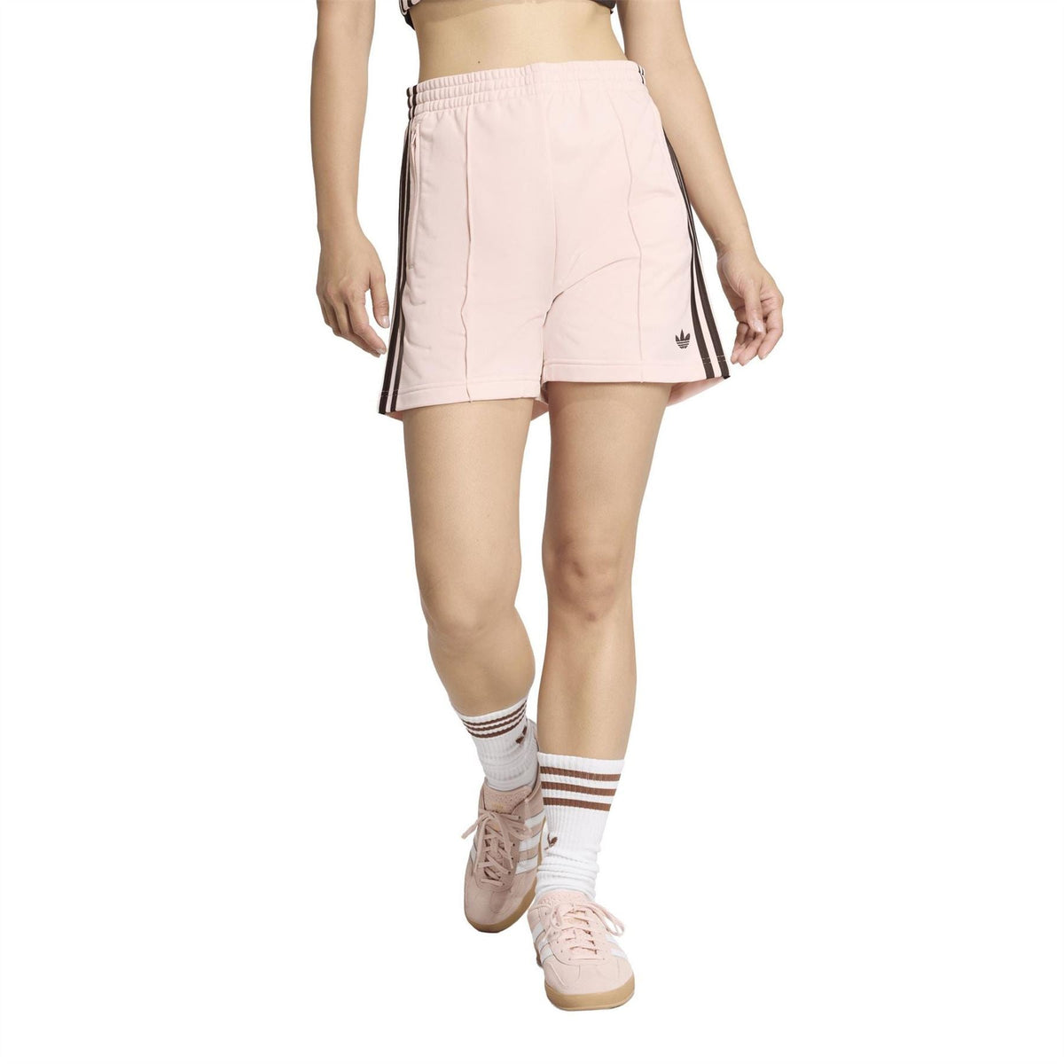 Light pink women's shorts with elastic waistband, black triple side stripes, and trefoil logo
